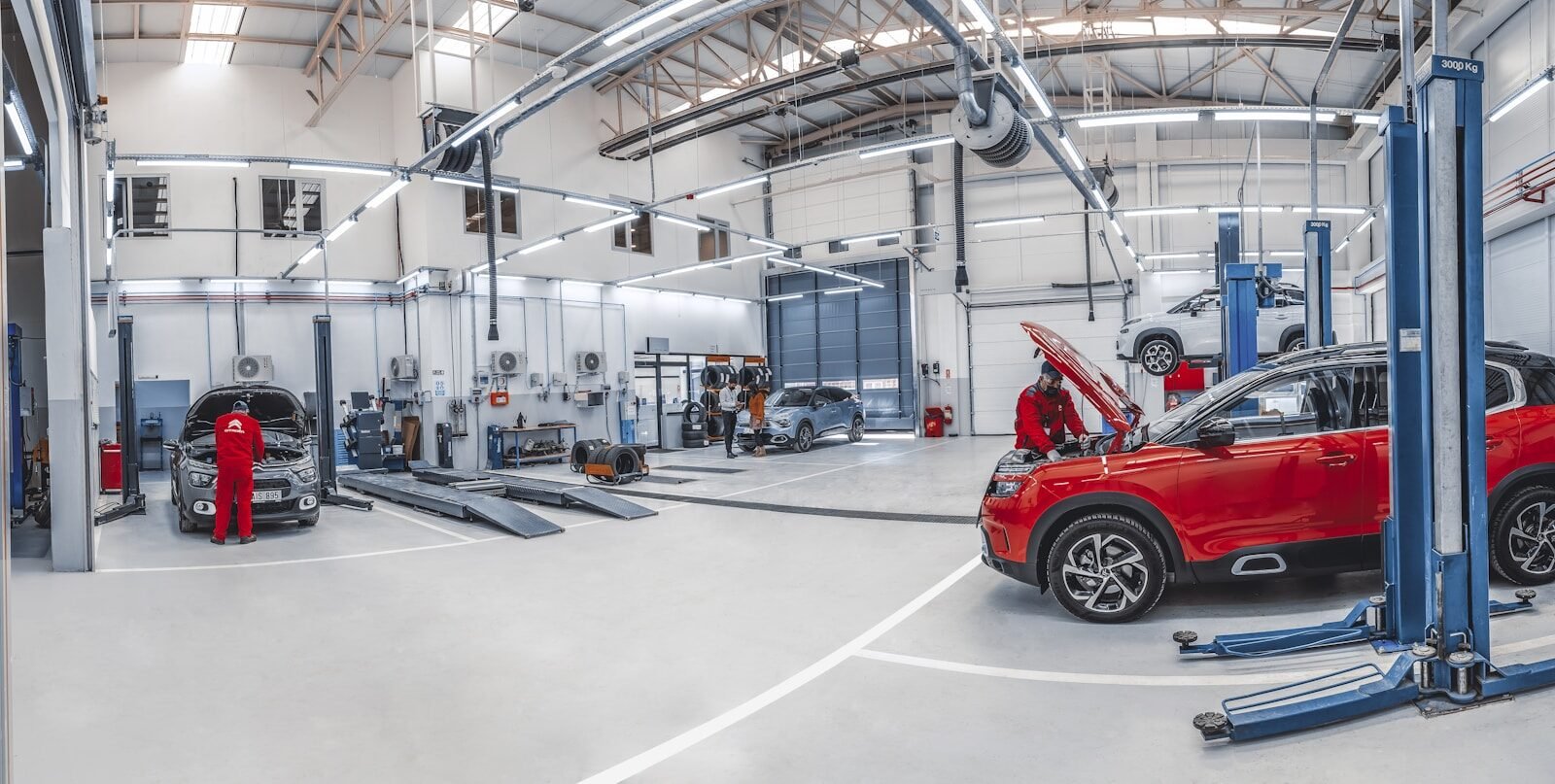 A red car is parked in a garage