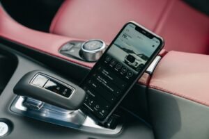 Smartphone displaying car interface in car console.