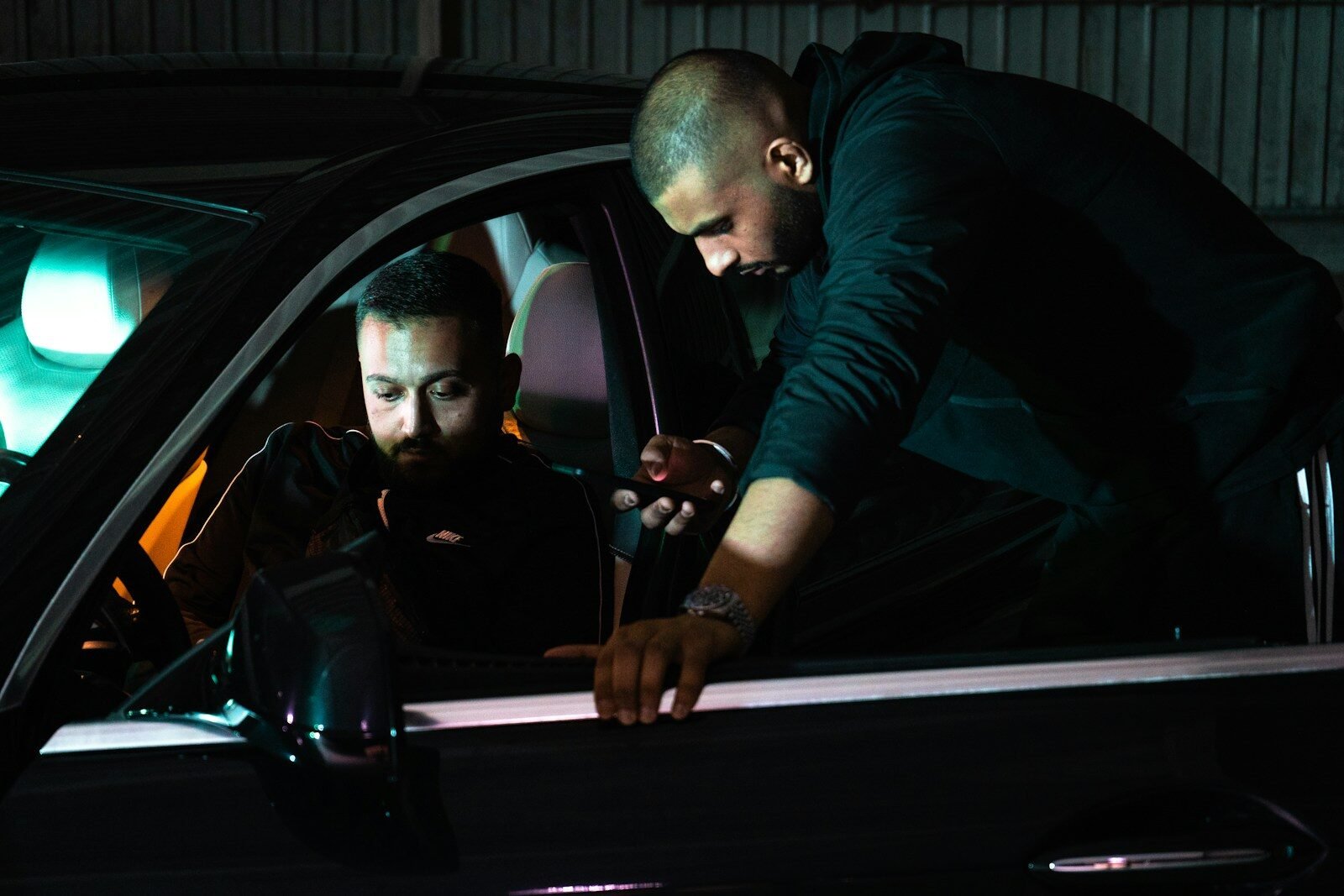 man in black long sleeve shirt driving car